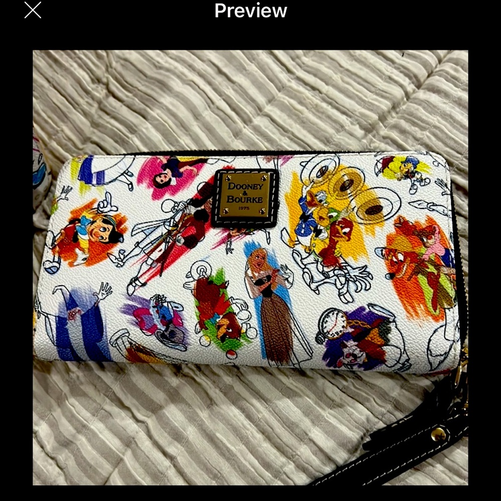 Dooley Disney print wallet.  Full size brand new never used.  Perfect condition.